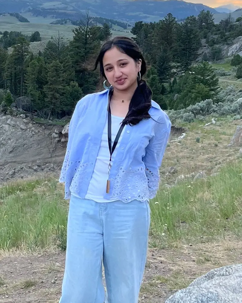 Zoha Waheed, author of the Shadow Pre-MD shadowing guide, standing outdoors in a light blue shirt