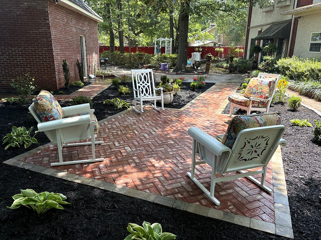After: A herringbone brick patio and garden path, ready for chairs the same week.