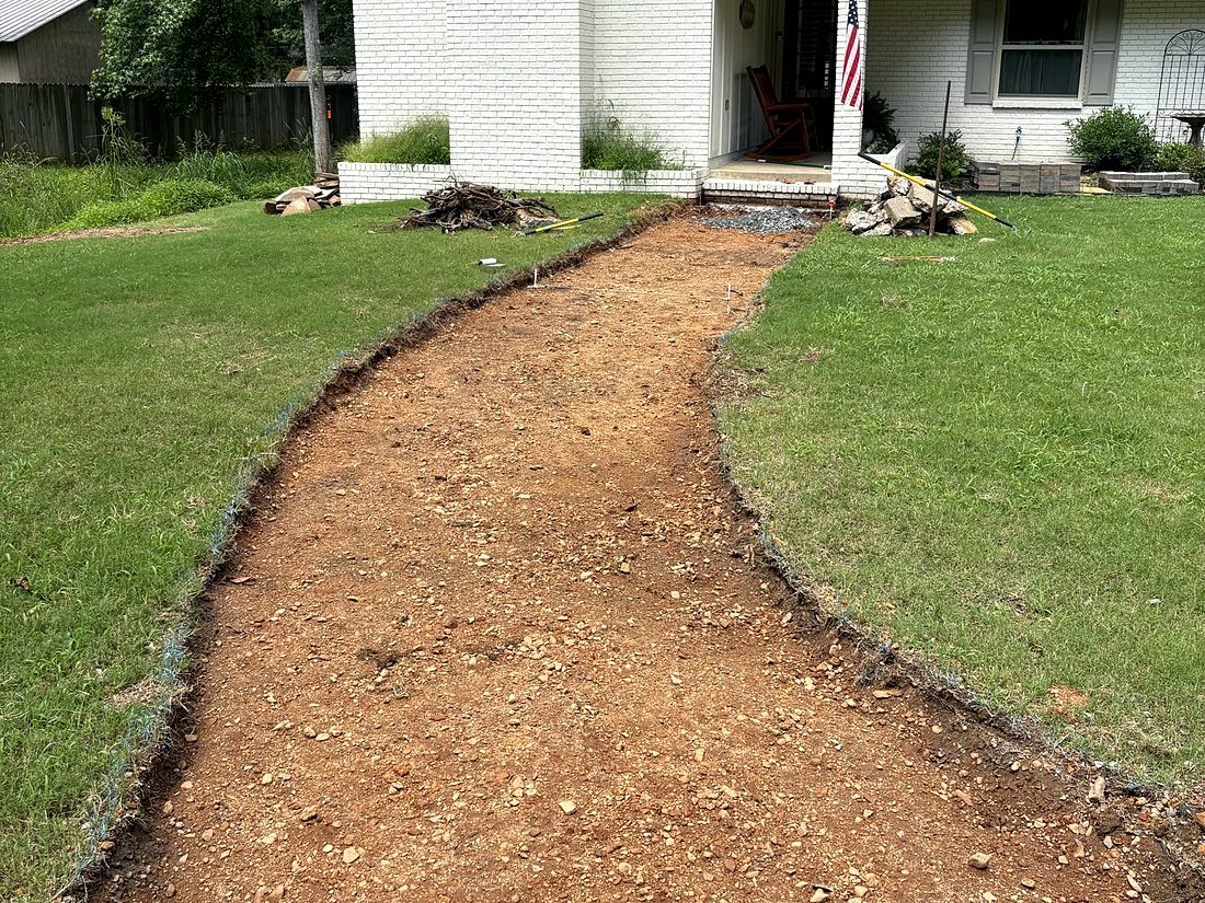 Before: A worn dirt path to the front door