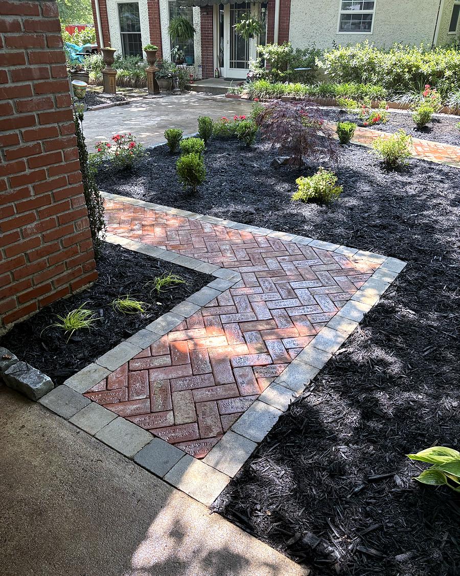 A herringbone brick walk through a new garden bed, built by Amanda's Villa