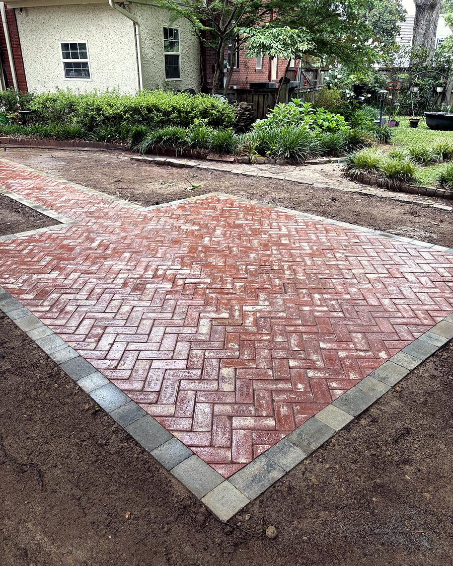 A herringbone brick patio, finished and edged, built by Amanda's Villa