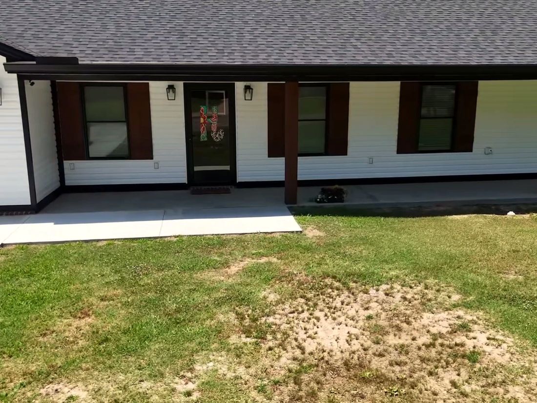 Before: Patchy grass in front of a covered porch