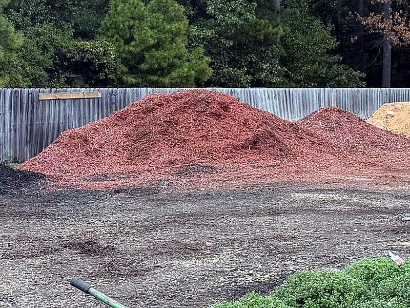 A pile of red mulch in the bulk yard at Amanda's Villa
