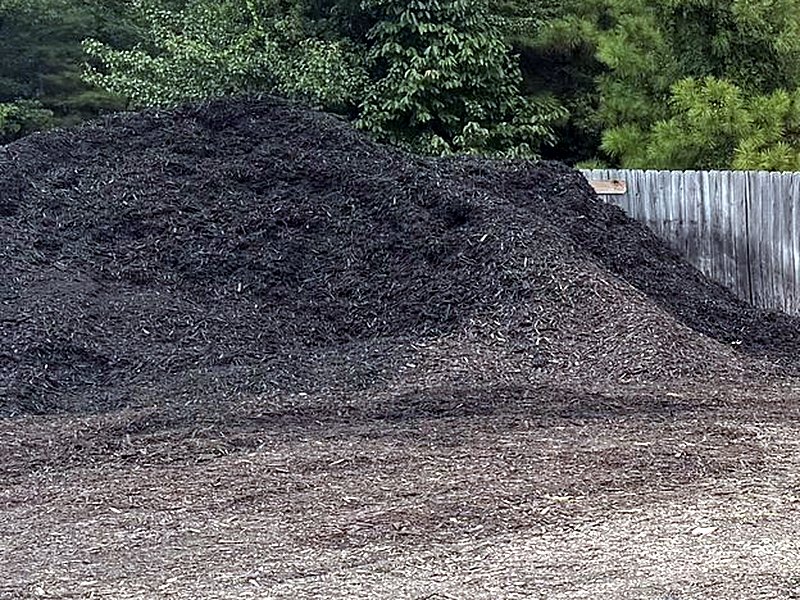 A pile of dark topsoil in the bulk yard at Amanda's Villa