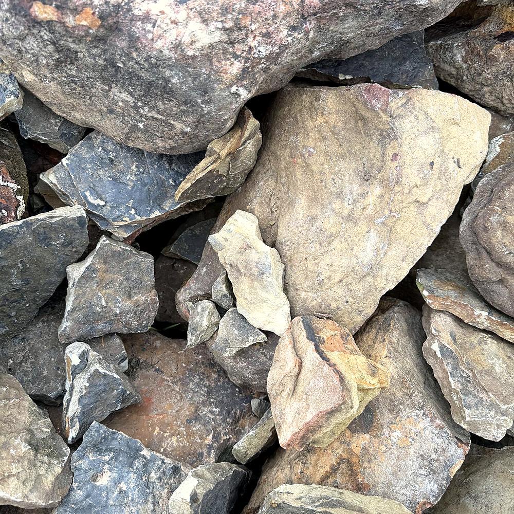 Rough gray fieldstone pieces stacked for landscaping at Amanda's Villa