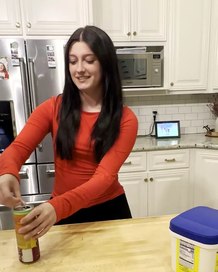 Anna Kate in a red shirt laughing at her kitchen island