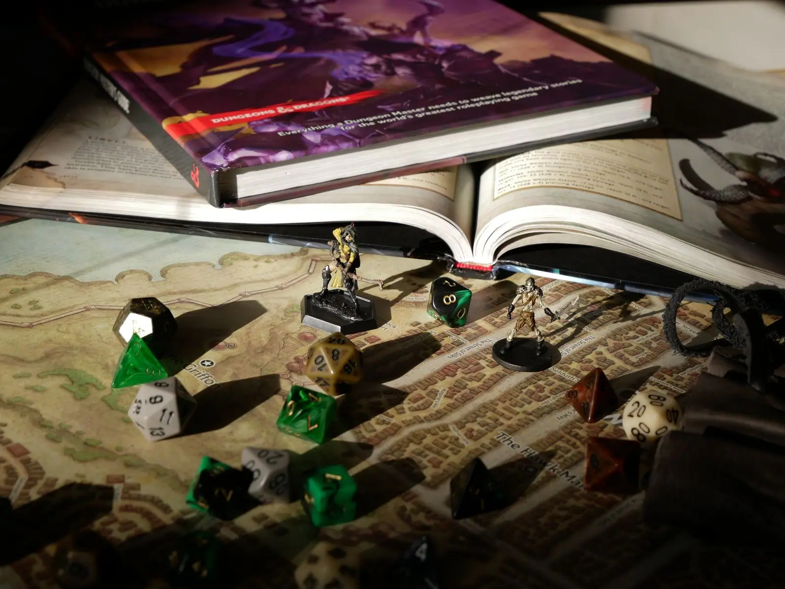 Polyhedral dice and painted miniatures on a fantasy map